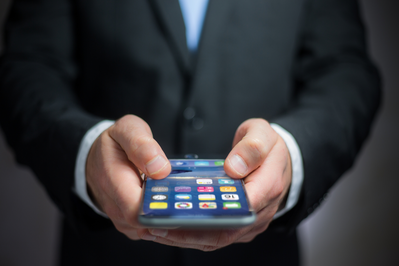 man holding cell phone with apps