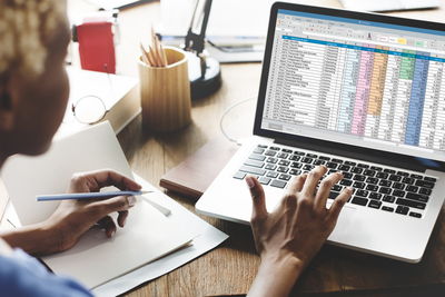 woman with document on laptop