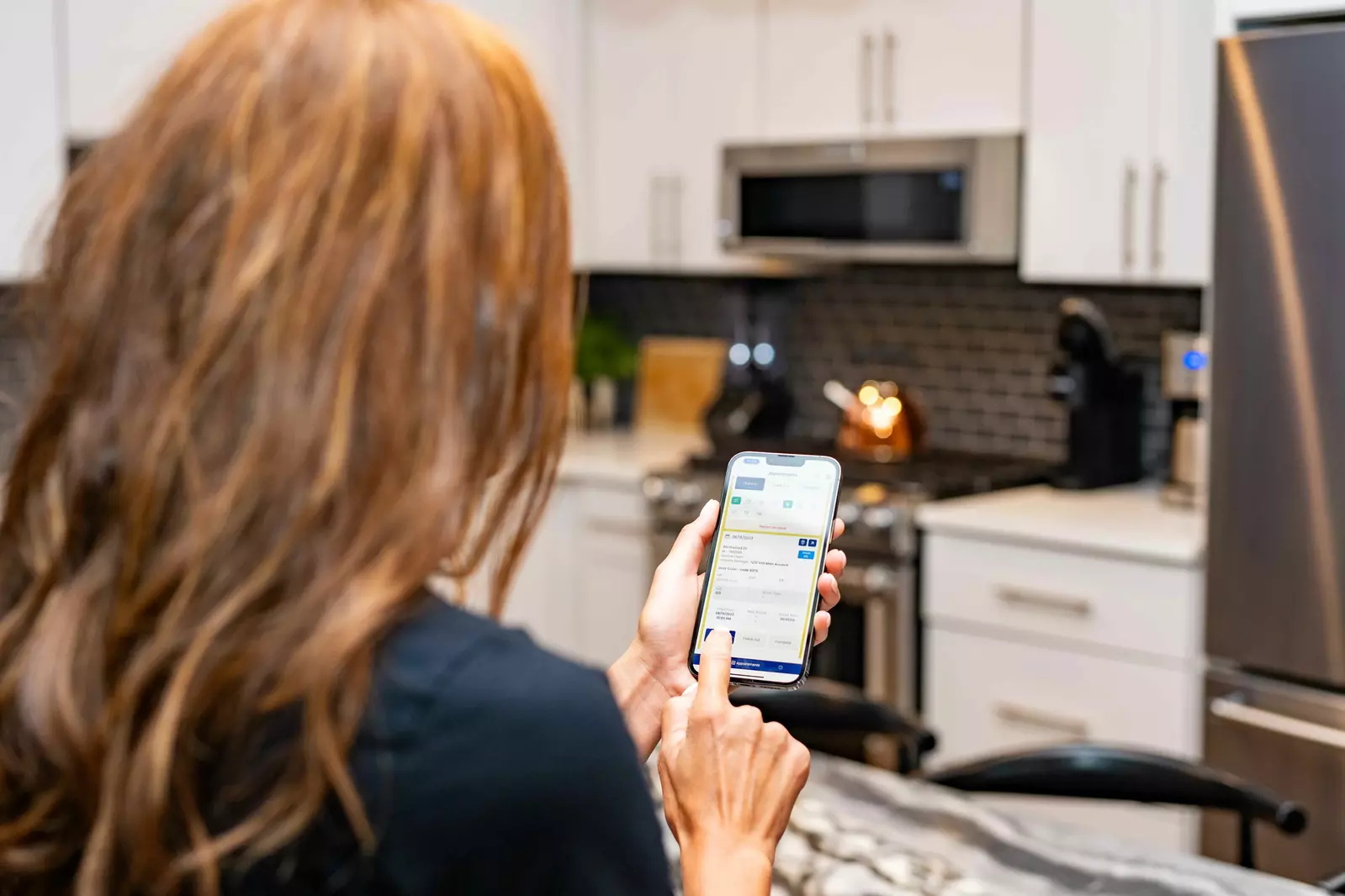 Woman using the Resort Cleaning app on a cellphone.