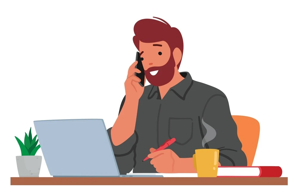 businessman talking on phone while doing paperwork